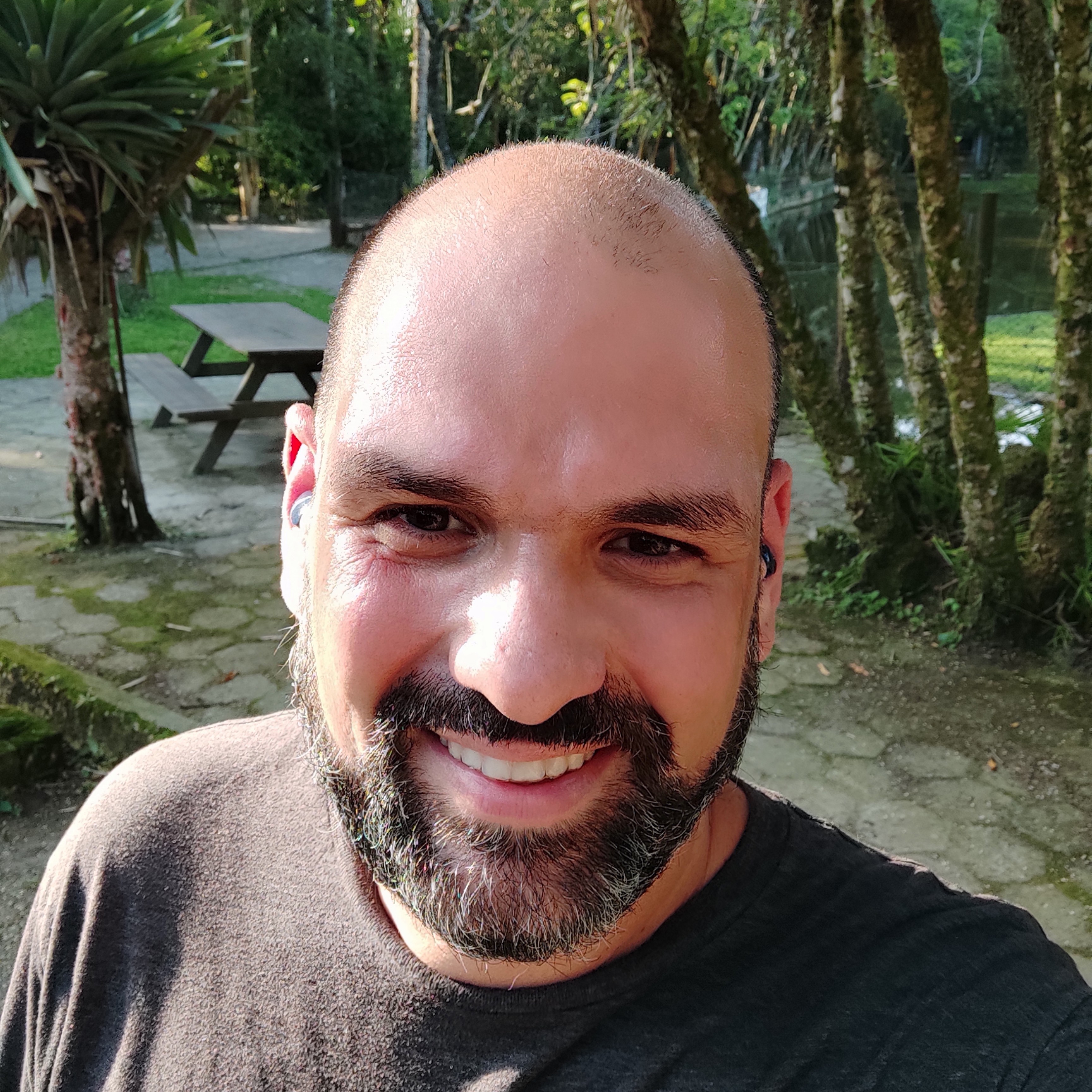 Rodrigo smiling on a selfie, gray beard and shaven head