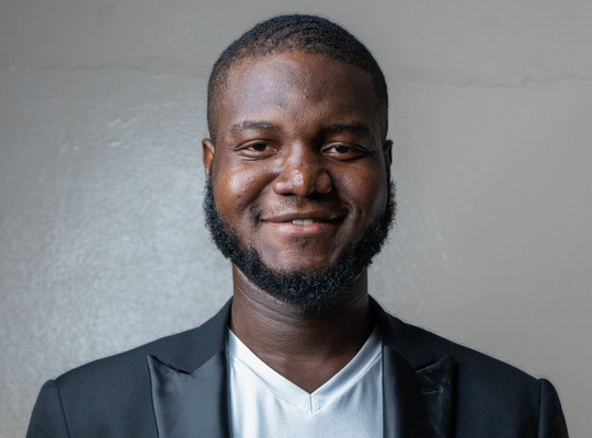 Portrait photo of Eddy Adegnandjou, a Django developer and Djangonaut Space participant, smiling at the camera.